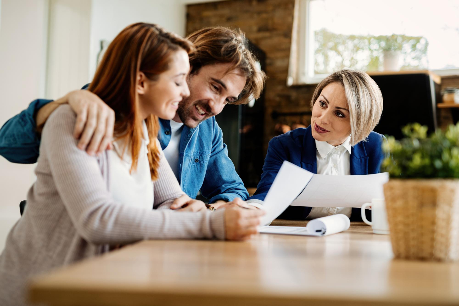 happy-financial-advisor-having-consultations-with-young-couple-their-home